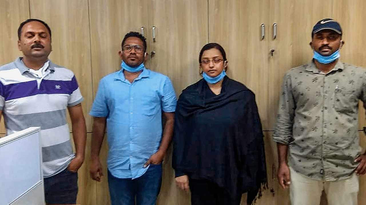 Kerala gold smuggling case accused Swapna Suresh and Sandeep Nair (both in middle) after they were arrested by the National Investigation Agency. Credits: PTI Photo