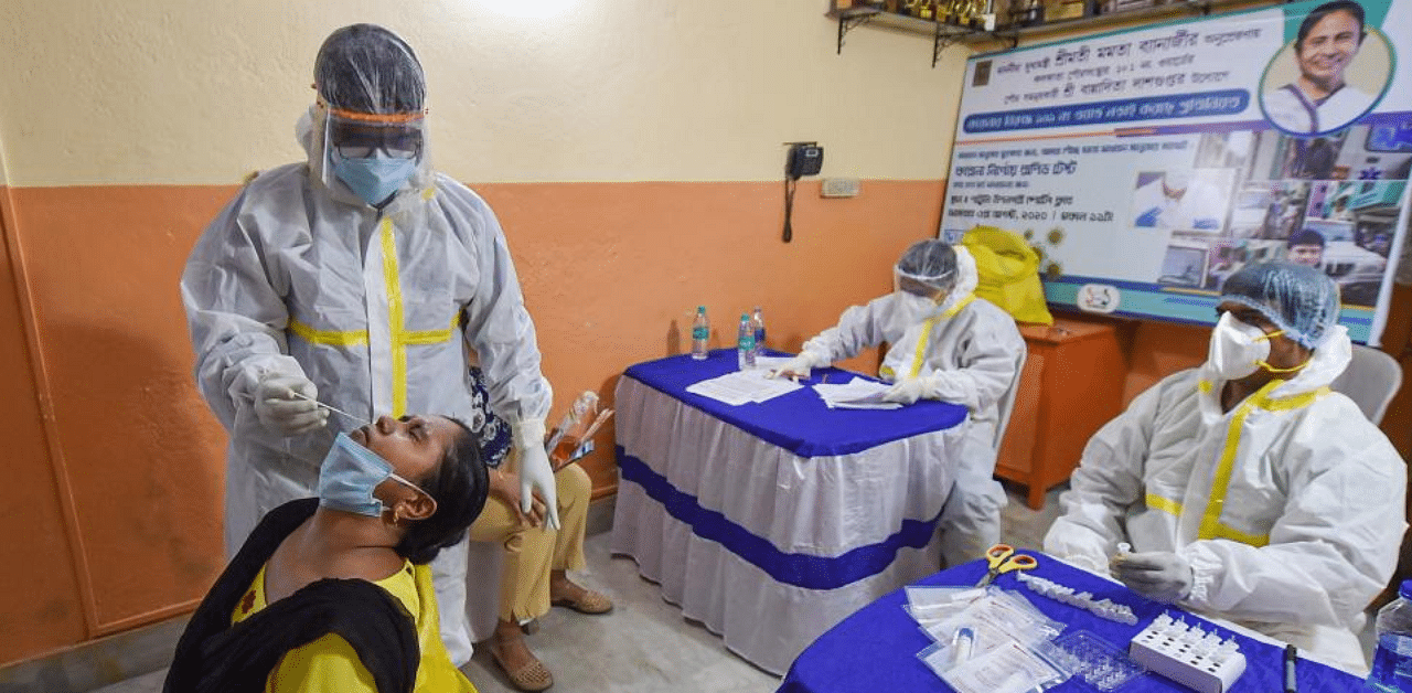  A health worker collects sample of a woman for Covid-19 test via Rapid Antigen Testing, in Kolkata, Monday, Aug 3, 2020.  Credit: PTI Photo