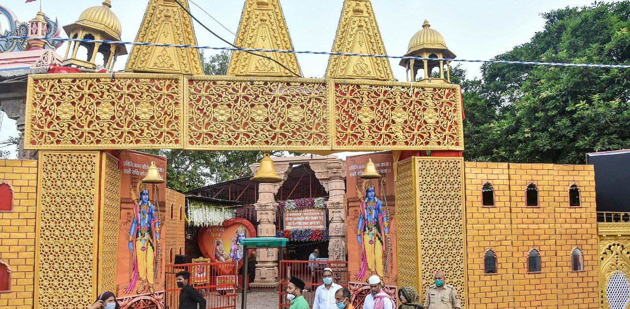 People move past the Ram Janmabhoomi Nyas workshop, ahead of the ground breaking ceremony of the 'Ram Mandir' in Ayodhya, Monday, Aug 3, 2020. Credit: PTI Photo