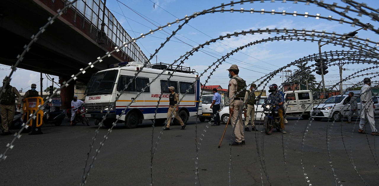 Police stand guard at a checkpoint during a curfew in Srinagar on August 4, 2020. - A curfew has been imposed across Indian Kashmir just two days before the first anniversary of New Delhi's abolition of the restive region's semi-autonomy, officials said late August 3, citing intelligence reports of looming protests. Credit: AFP Photo