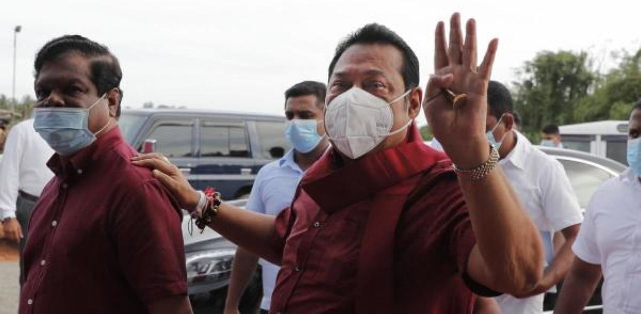 Sri Lankan Prime Minister Mahinda Rajapaksa, right, greets his supporters during an election rally in Colombo, Sri Lanka. Credit: AP