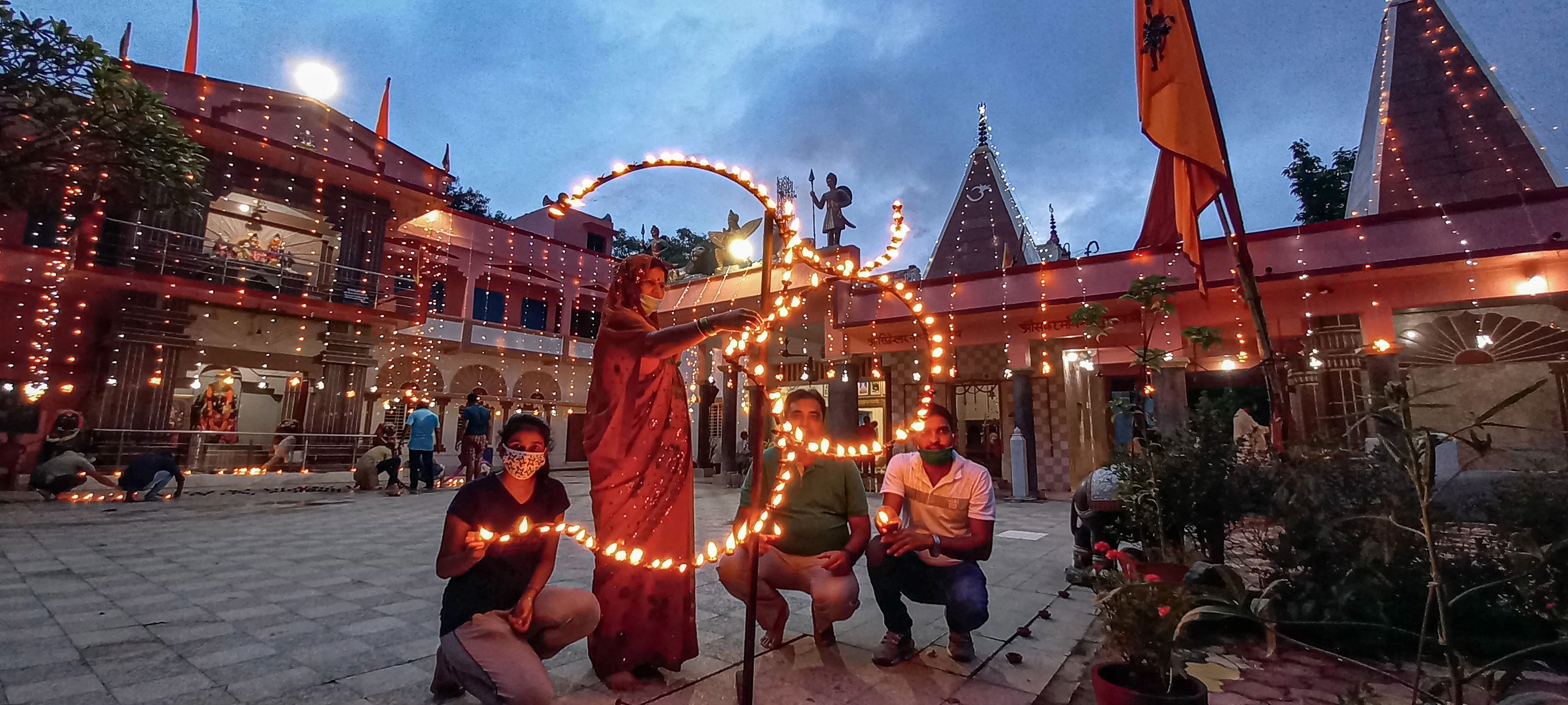 Hindu devotees light earthen lamps at Tapovan Ram Mandir to celebrate the groundbreaking ceremony of the Ayodhya's Ram Temple. Credits: PTI Photo