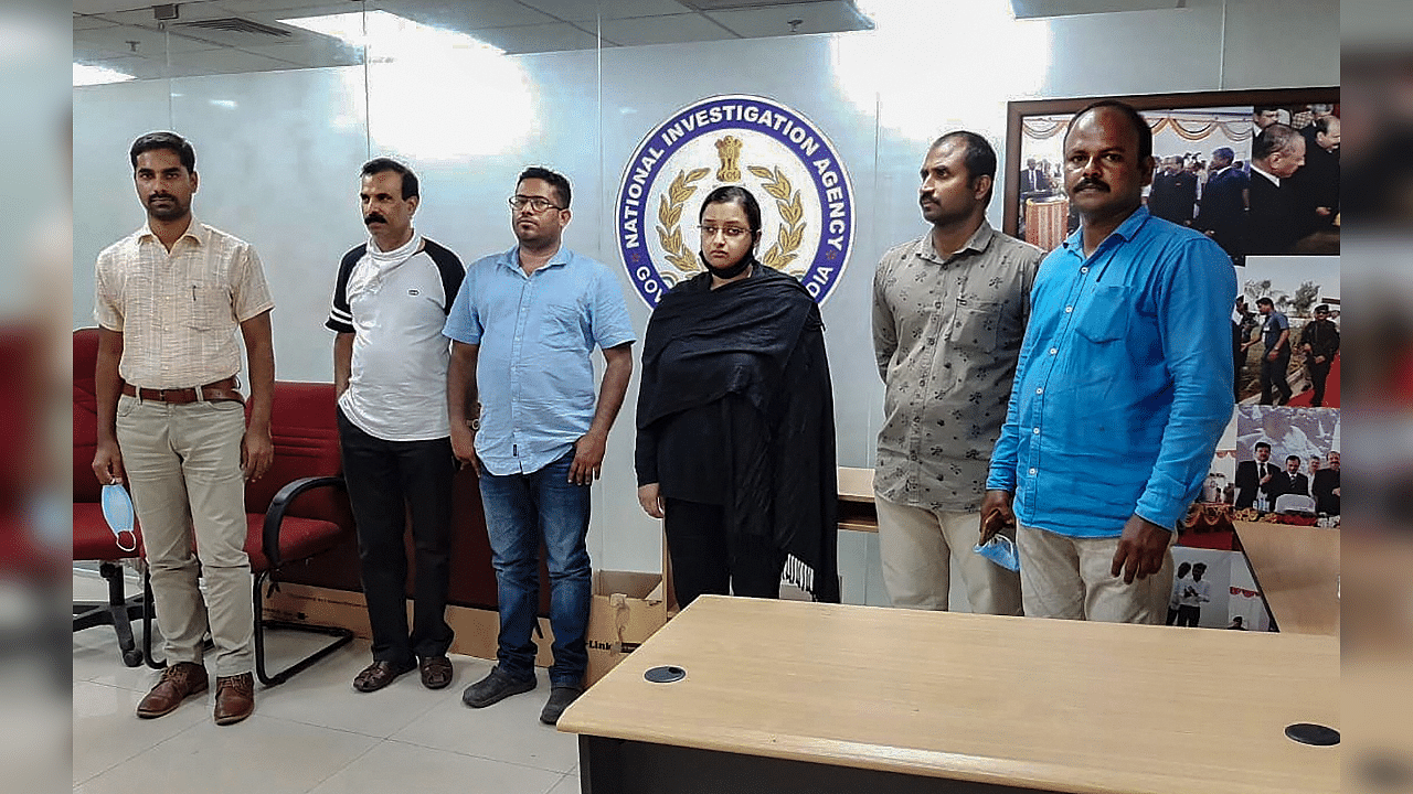 Kerala gold smuggling case accused Swapna Suresh and Sandeep Nair (both in middle) after they were arrested by the National Investigation Agency in Bengaluru. Credits: PTI Photo