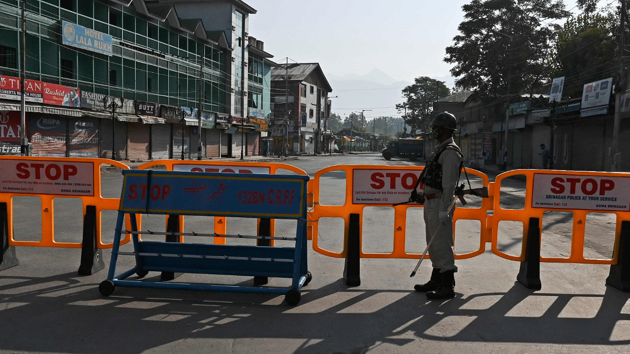 A paramilitary soldier stands guard at a roadblock during the one-year anniversary of the restive region being stripped of its autonomy in Srinagar. Credits: AFP Photo