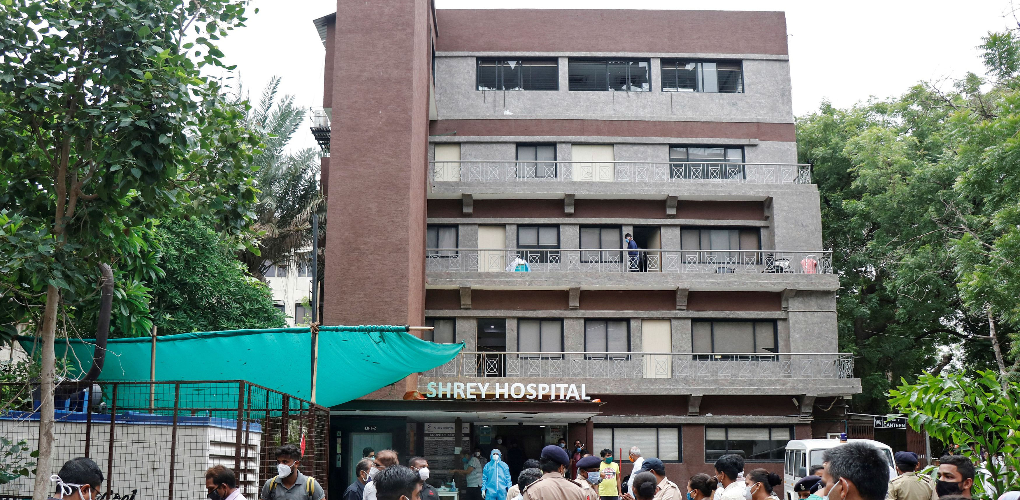 Police officers and relatives stand outside a hospital where a fire broke out inside an intensive Care Unit (ICU) treating patients infected with the coronavirus disease (COVID-19) in Ahmedabad. Credit: Reuters