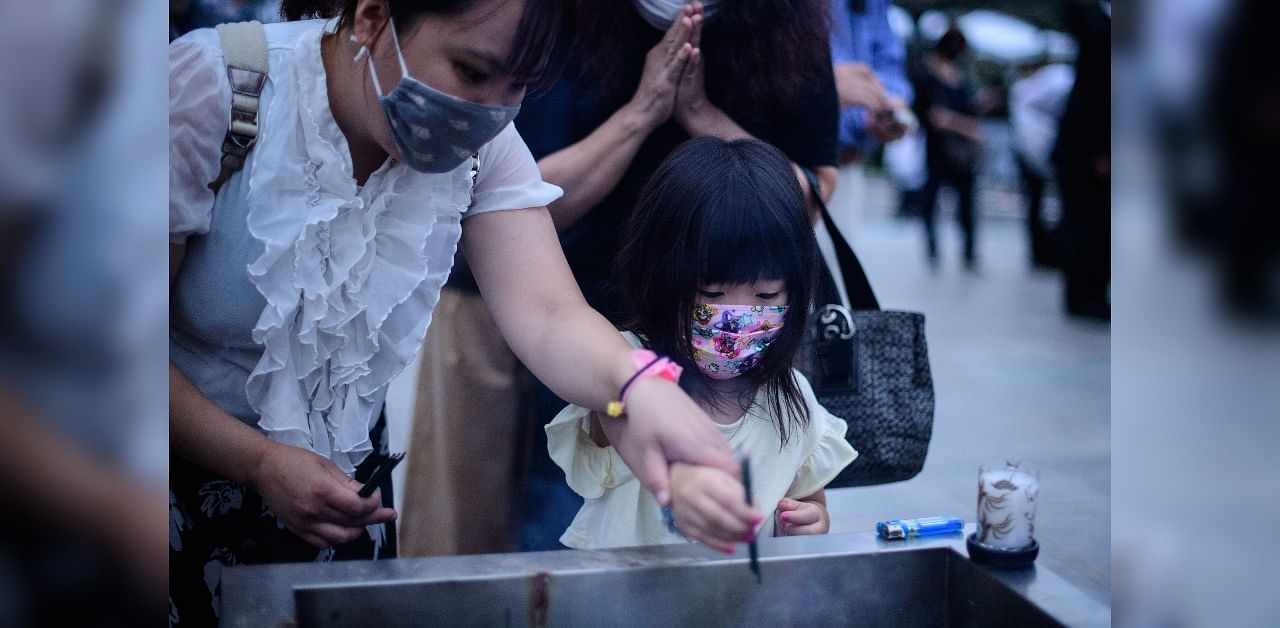 Visitors burn incense to pay tribute to the atomic bomb victims in front of the cenotaph at the Hiroshima Peace Memorial Park in Hiroshima on August 6, 2020 to mark 75 years since the world's first atomic bomb attack. Credit: AFP Photo