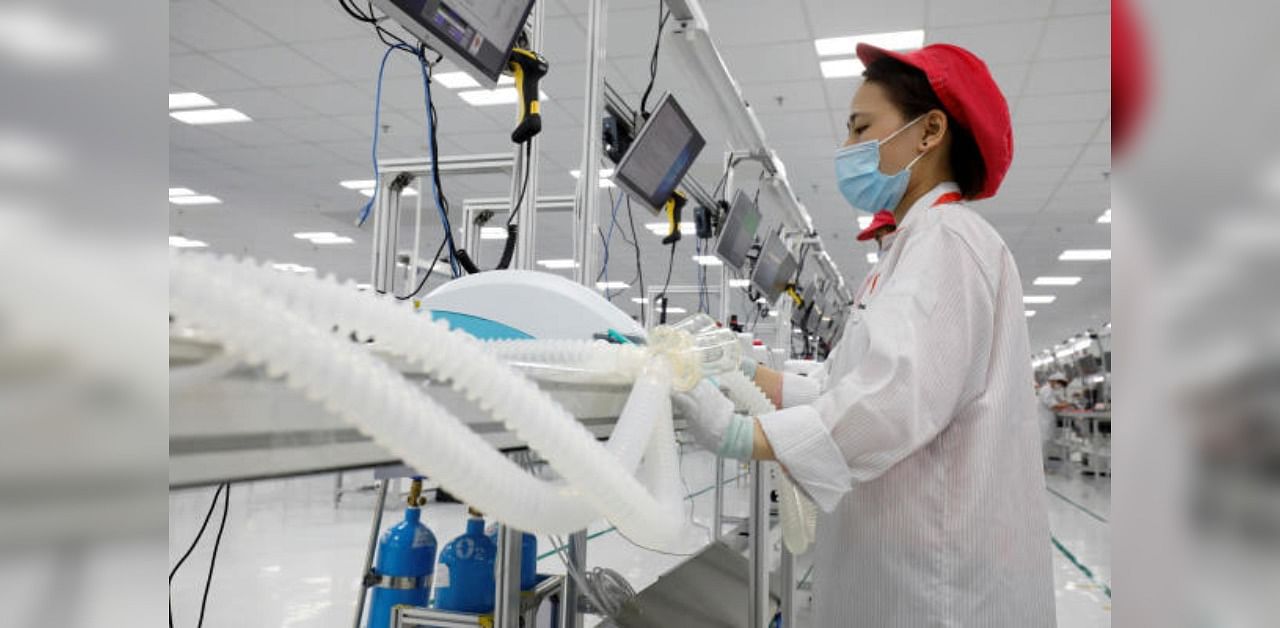 A woman works at an assembly line to produce ventilators amid the spread of the coronavirus disease. Credit: Reuters