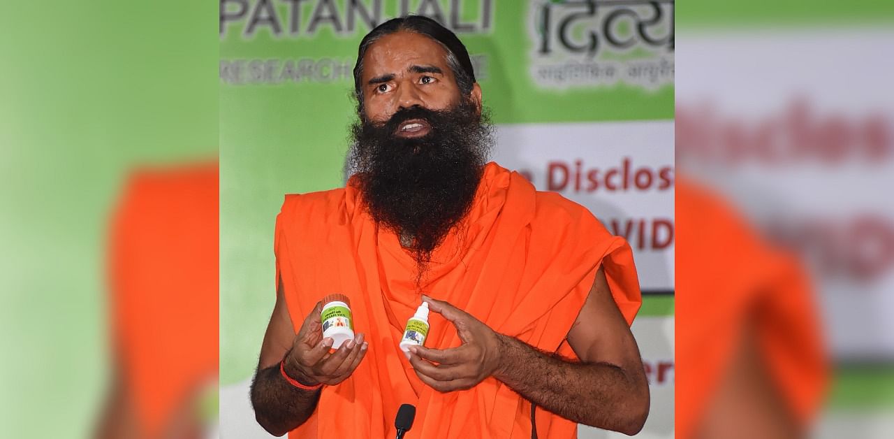 Yoga guru Ramdev addresses the media during the launch of 'Coronil' and 'Swasari', ayurvedic medicines claimed by Patanjali to cure coronavirus disease. Credit: PTI Photo