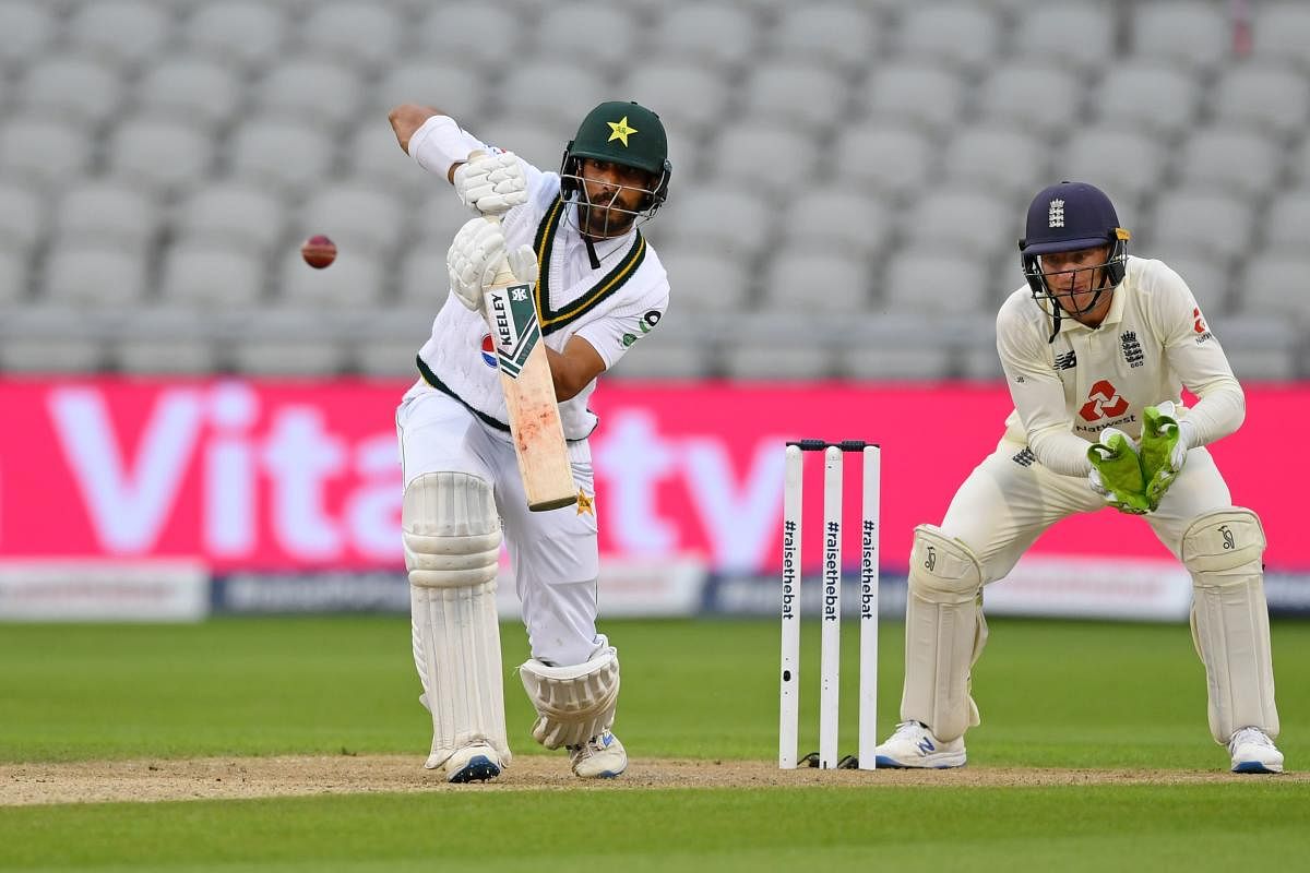 Pakistan's Shan Masood (L) plays a shot in front of England's wicket keeper Jos Buttler (R) during the first day of the first Test cricket match between England and Pakistan at Old Trafford in Manchester, northwest England. Credit: AFP