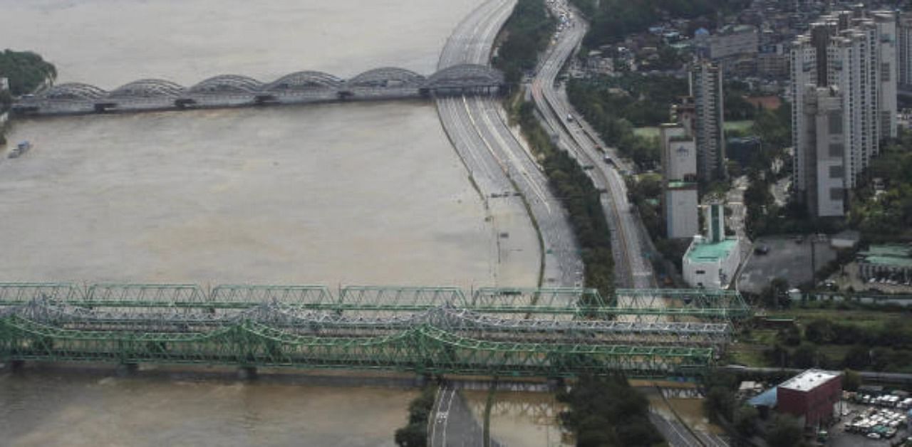 A part of a main road near the Han River is flooded due to heavy rain in Seoul, South Korea. Credit: AP