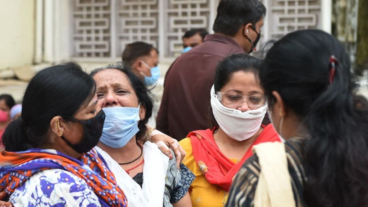 Relatives grief for their loved one outside the mortuary room of the Civil Hospital in Ahmedabad on August 6, 2020, after a fire broke early in the morning in the intensive care unit of the Shrey Hospital killing 8 coronavirus patients. Credit: AFP