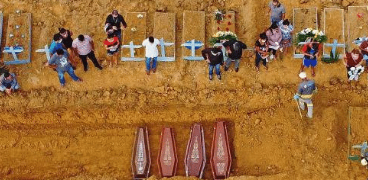 A burial taking place at an area where new graves have been dug up at the Nossa Senhora Aparecida cemetery in Manaus, in the Amazon forest in Brazil. Credit: AFP Photo