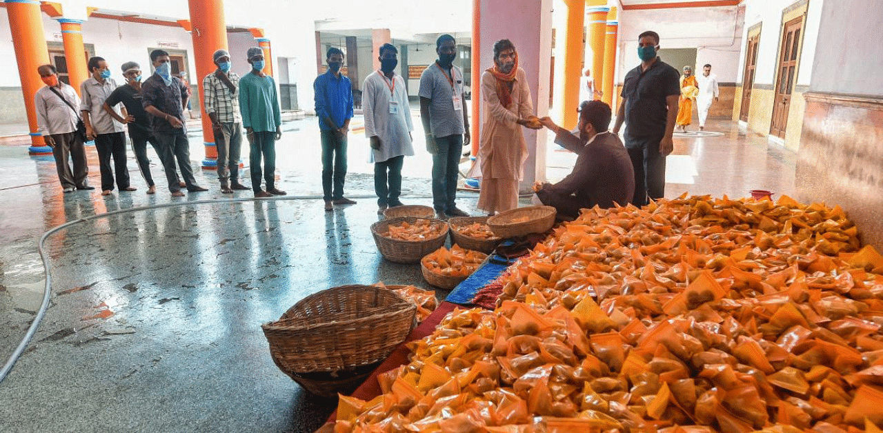 Prasad being distributed among people after the Bhoomi Pujan for the construction of Ram Temple. Credit: PTI Photo