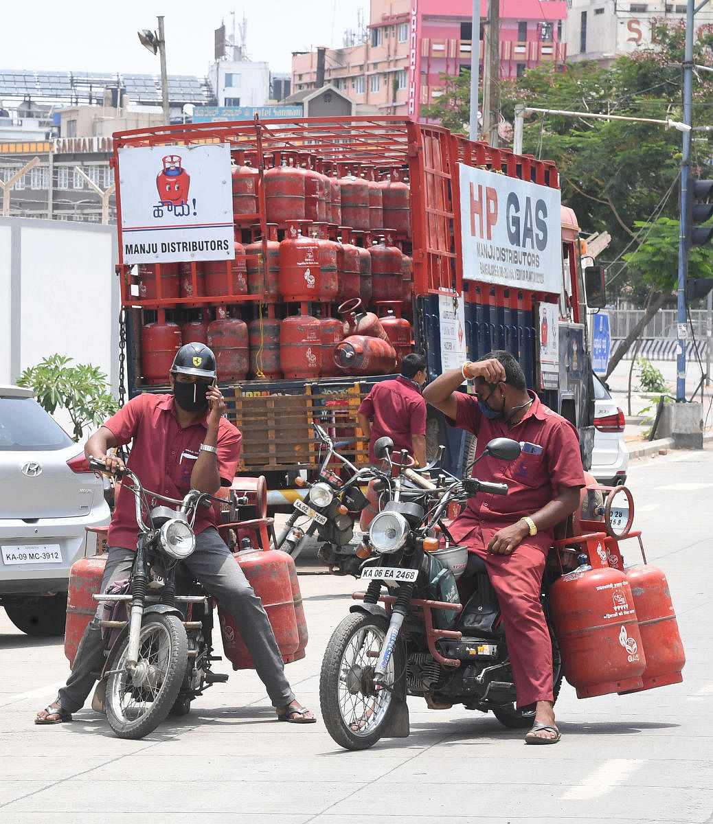 LPG gas cylinder distributer having a word each other during their routine duty at Mejestic in Bengaluru on Friday. Photo Srikanta Sharma R.