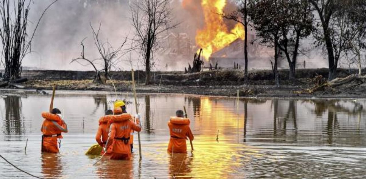 National Disaster Response Team (NDRF) personnel carry out search and rescue operations after two firemen of Oil India Limited went missing since an oil well at the company’s Baghjan oilfield exploded, in Assam’s Tinsukia district. Credit: PTI hoto