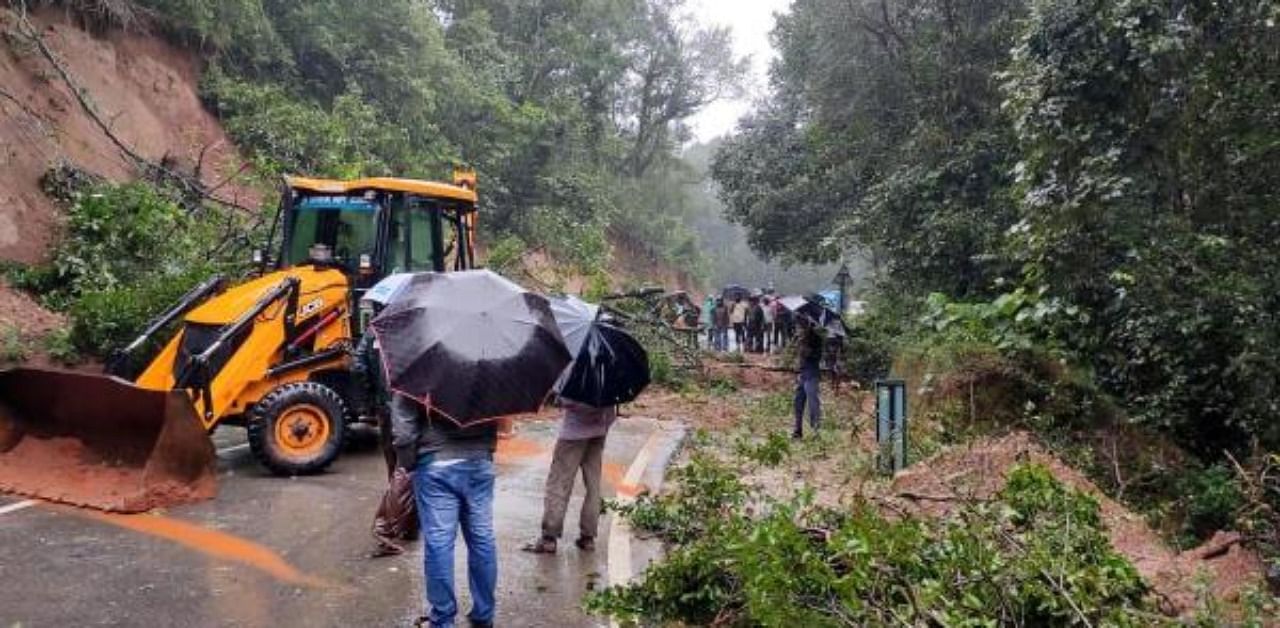 An earthmover removes the debris on Jaipura-Sringeri Road that fell after a landslide following incessant heavy rainfall, at Sringeri near Chikmagalur, Thursday, Aug 6, 2020. Credit: PTI Photo