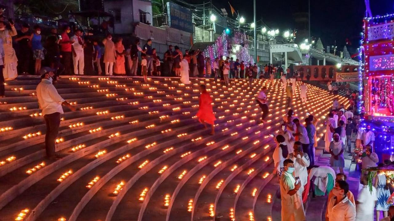 People light earthen lamps and candles at Har Ki Pauri Ghat, to celebrate the groundbreaking ceremony of the Ayodhya's Ram Temple. Credit: PTI