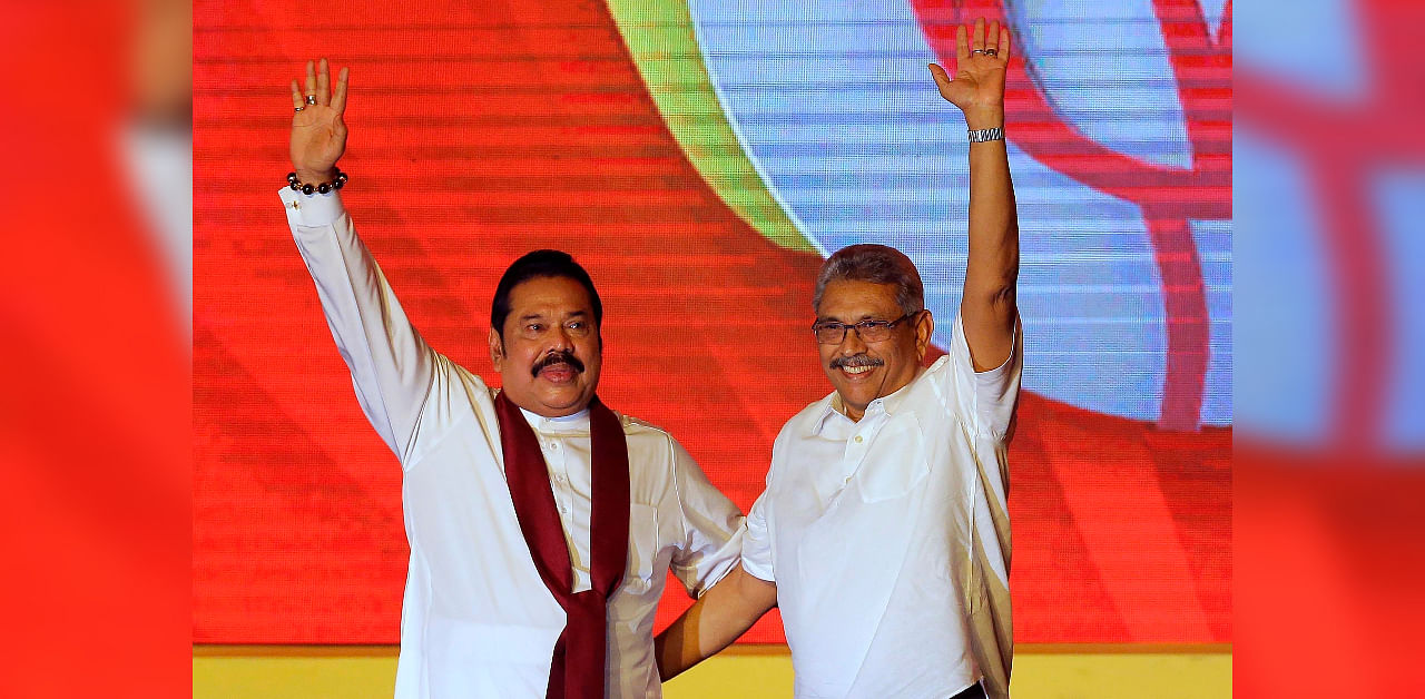 Former Sri Lankan President Mahinda Rajapaksa, left, and former Defense Secretary and his brother Gotabaya Rajapaksa wave to supporters during a party convention held to announce the presidential candidacy in Colombo, Sri Lanka. Sri Lanka‚Äôs powerful Rajapaksa brothers secured a landslide victory in the parliamentary election, giving them nearly the two-thirds majority of seats required to make constitutional changes, according to results released Friday, Aug. 7, 2020. Credit: AP/PTI File Photo