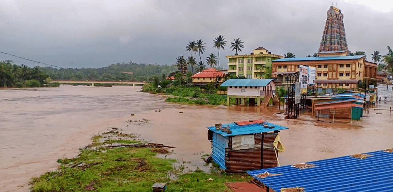  A parking area is flooded due to overflowing Tunga river following incessant rainfall, at Sringeri near Chikmagalur. Credit: PTI Photo