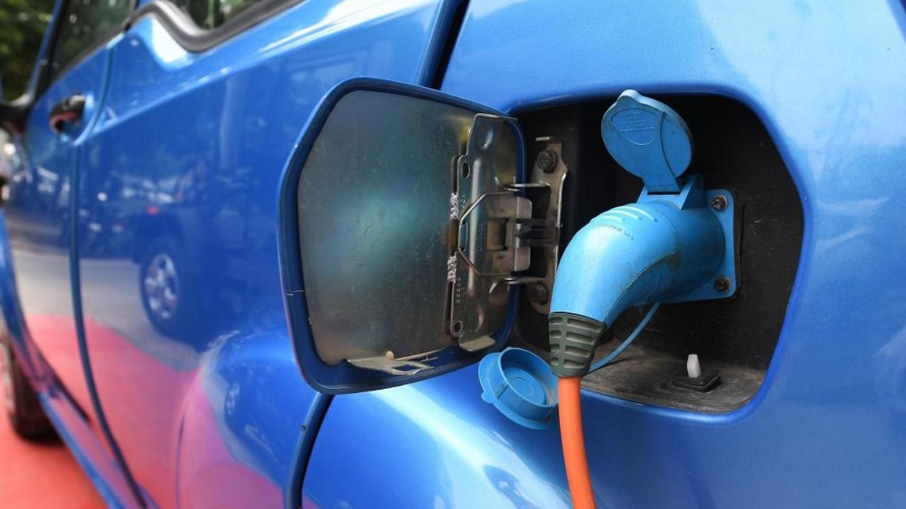 This photo taken on July 21, 2017 shows Mahindra's electric car "e2o Plus" plugged in for charging at a showroom in New Delhi. Credit: AFP/file