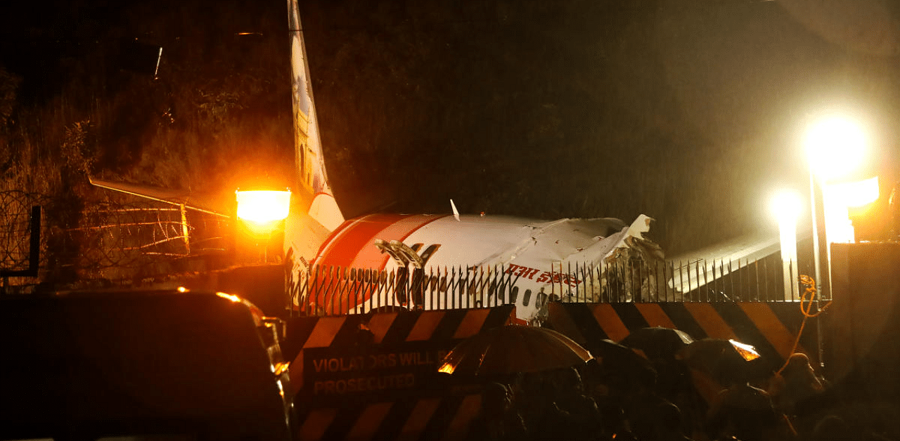 Mangled remains of an Air India Express flight en route from Dubai after it skidded off the runway while landing, at Karippur in Kozhikode. Credit: PTI