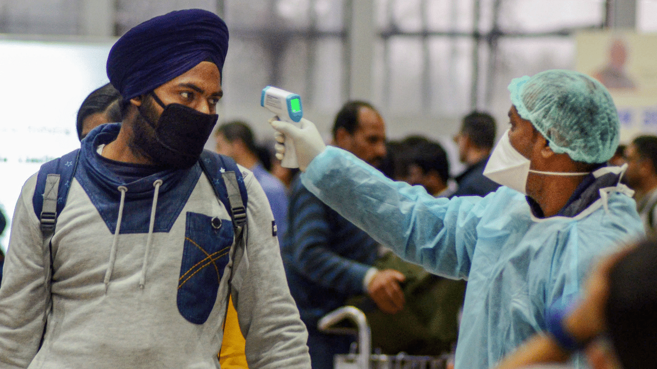 A medic official uses thermal screeing device on a passenger in the wake of deadly coronavirus. Credits: PTI Photo