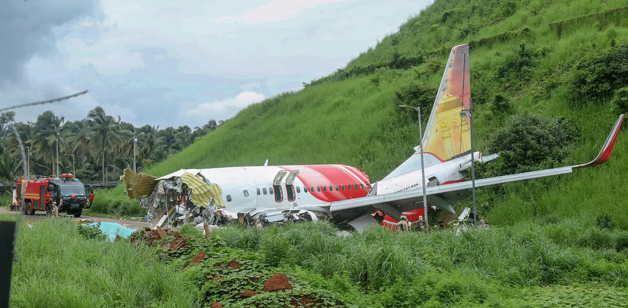 Mangled remains of an Air India Express flight, en route from Dubai, after it skidded off the runway while landing on Friday night, at Karippur in Kozhikode. Credit: PTI Photo