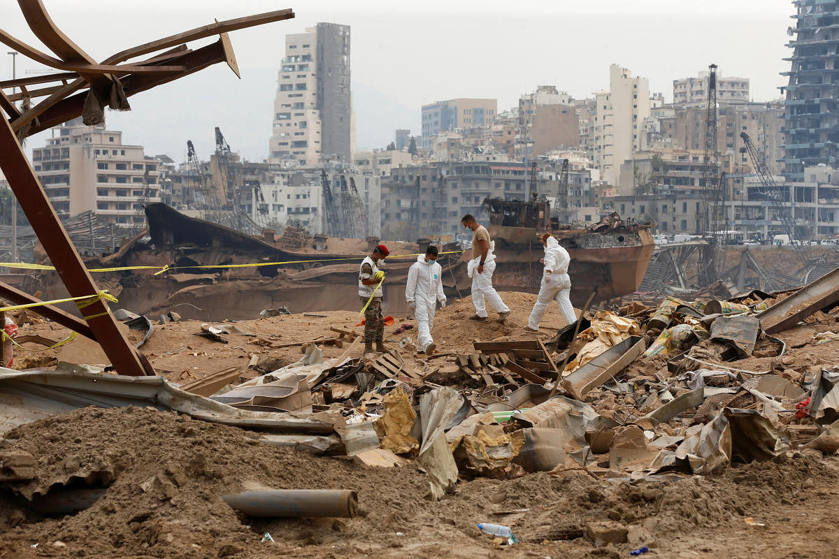Members of forensic team walk near rubble at the site of Tuesday's blast, at Beirut's port area, Lebanon. Credit: Reuters