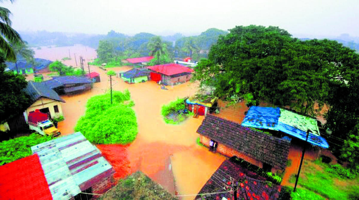 Houses located in the low-lying areas, including in Aladka in Panemangaluru, are inundated with flood waters on Saturday. DH Photo