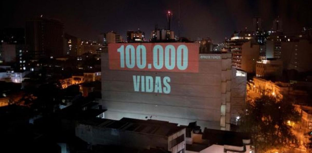 A projection on a building honours the 1,00,000 victims who died of the novel coronavirus in Brazil as the country became the second in the world to pass the grim milestone, in Botafogo neighbourhood in Rio de Janeiro. Credit: AFP