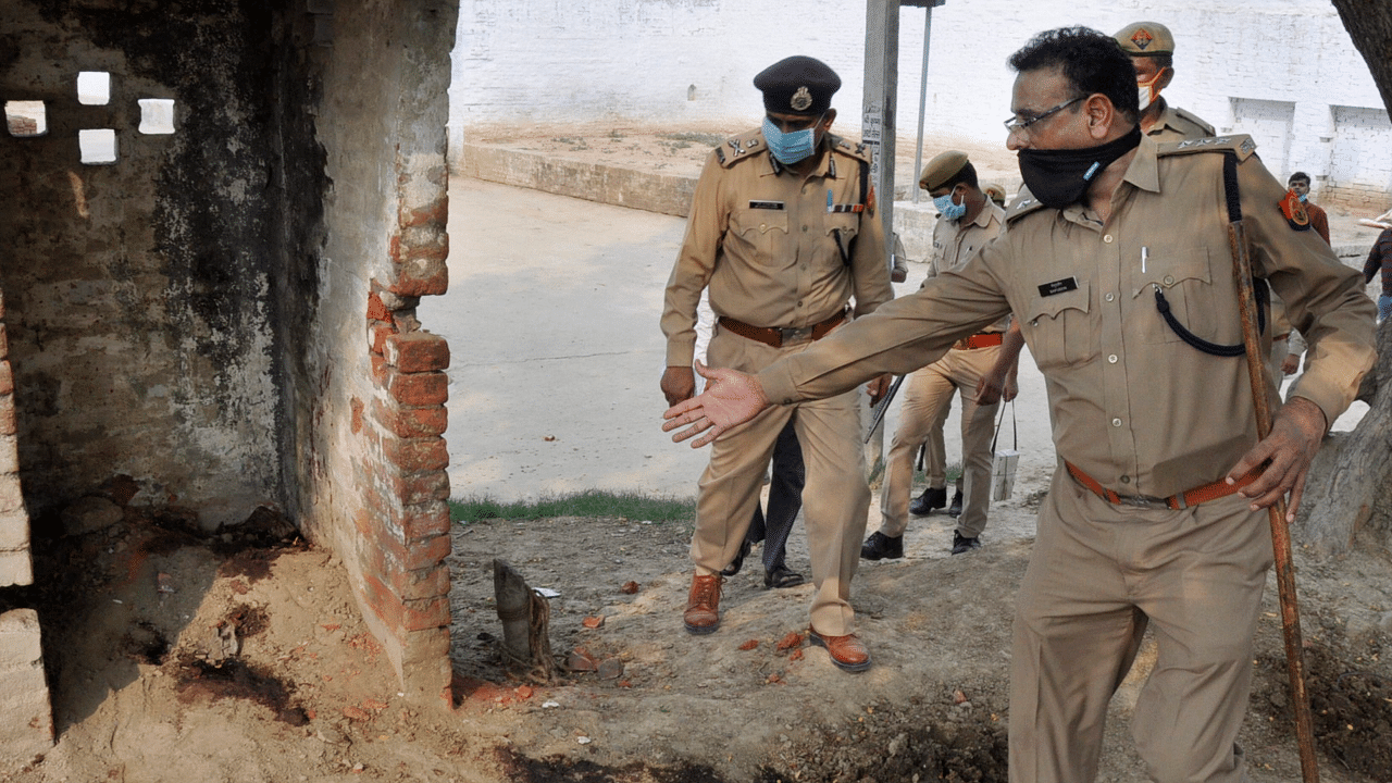 ADG Law and Order Prashant Kumar being shown a site during a visit to the Bikhru village after an encounter between the police and history sheeter Vikas Dubey. Credits: PTI Photo
