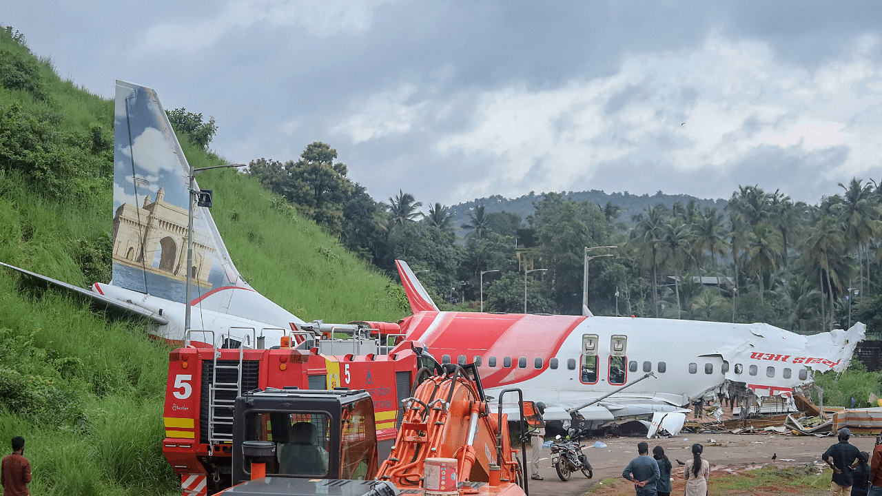 Mangled remains of an Air India Express flight, en route from Dubai, after it skidded off the runway while landing on Friday night, at Karippur in Kozhikode. Credits: PTI Photo
