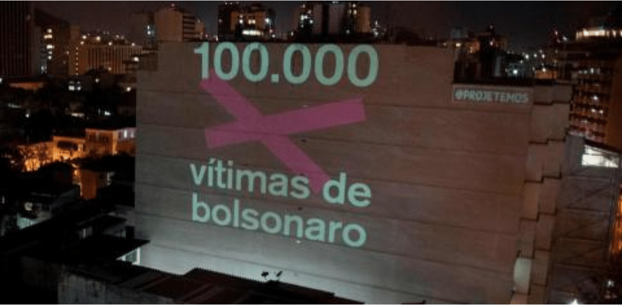 A projection on a building honouring the 100,000 victims who died of the novel coronavirus in Brazil reads "100,000 Victims of (Brazilian President Jair) Bolsonaro" as the country became the second in the world to pass the grim milestone. Credit: AFP Photo