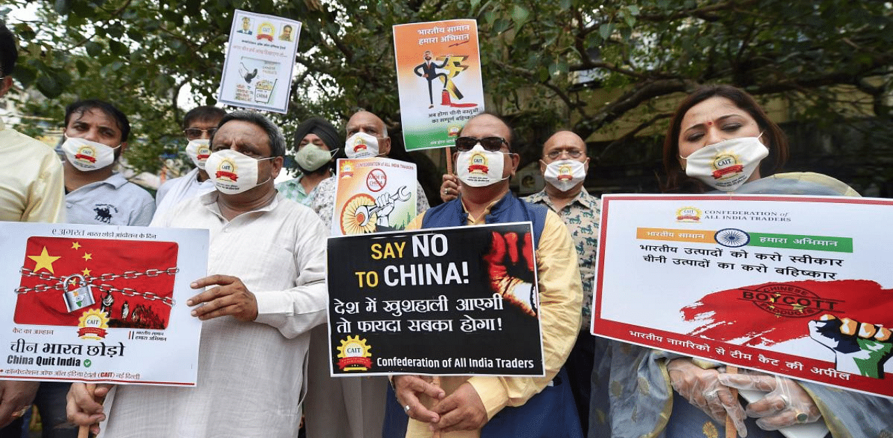 Members of Confederation of All India Traders (CAIT) stage a protest for 'China Quit India', at Sadar Bazar, in New Delhi, Sunday. Credit: PTI Photo