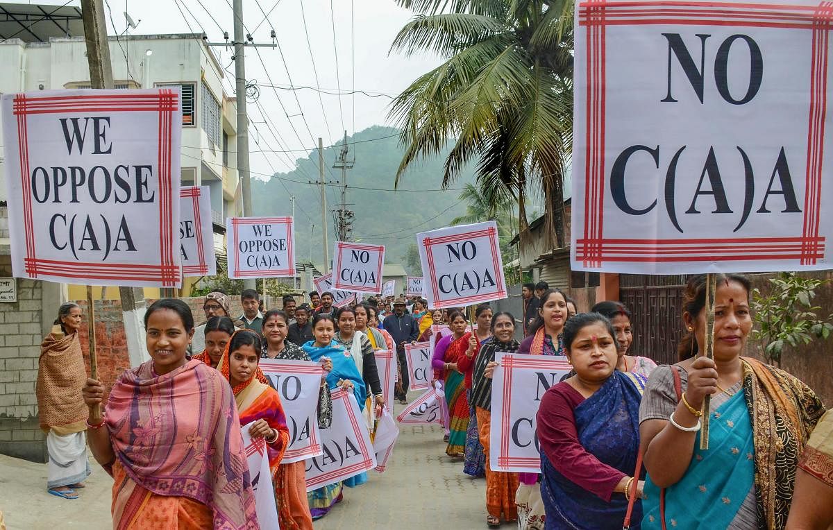Women hold placards as they march during a demonstration against the Citizenship Amendment Act (CAA) in Guwahati, Saturday, Dec. 21, 2019. Credit: PTI Photo