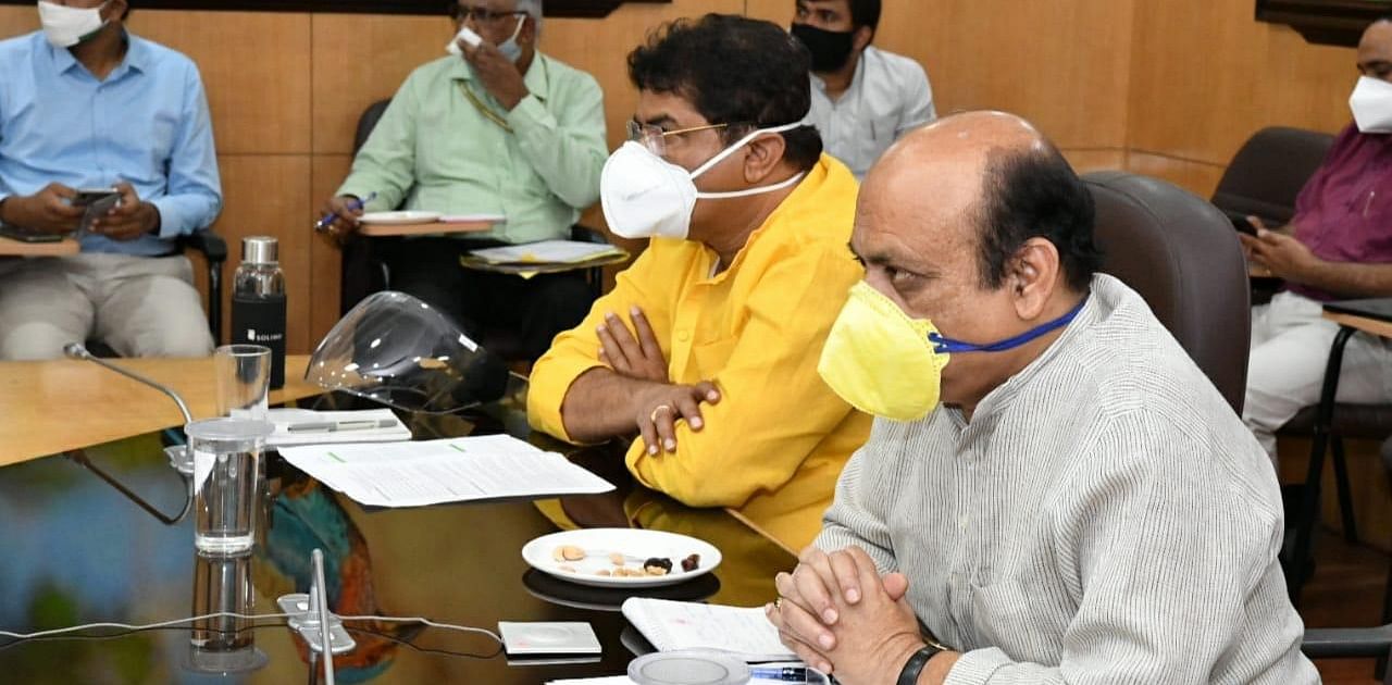 Revenue Minister R Ashoka and Home Minister Basavaraj Bommai at the PM’s video conference on the flood situation.