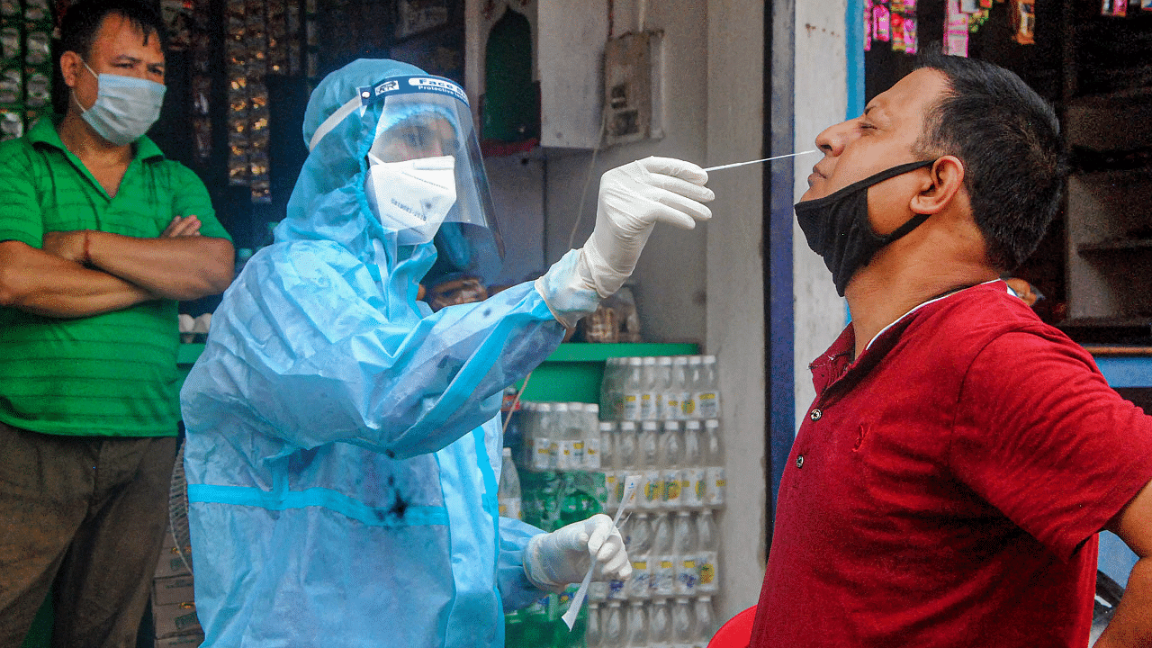 A health worker collects sample of a person for Covid-19 test via Rapid Antigen Testing. Credits: PTI Photo