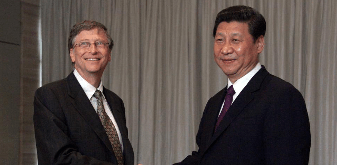 China's President Xi Jinping (R) shaking hands with Microsoft founder Bill Gates. Credit: AFP Photo