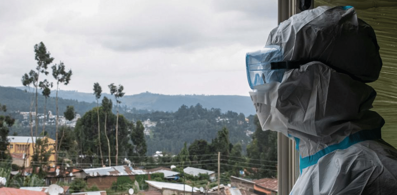 A doctor in PPE gets fresh air after a 6-hour shift treating patients infected with the Covid-19 in the ICU at Saint Petros Hospital in Addis Ababa. Credit: AFP Photo
