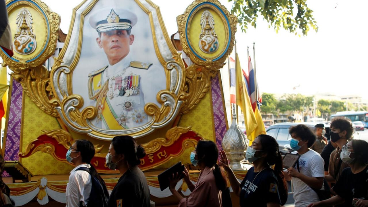 Demonstrators walk past a portrait of Thai King Maha Vajiralongkorn during a protest demanding the resignation of Thailand's Prime Minister Prayuth Chan-o-cha, in Bangkok. Credit: Reuters/file