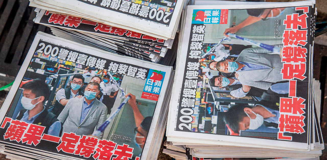 Copies of the Apple Daily newspaper - paid for by a collection of pro-democracy district councillors - sit on a cart before being handed out in Hong Kong. Credit: AFP Photo