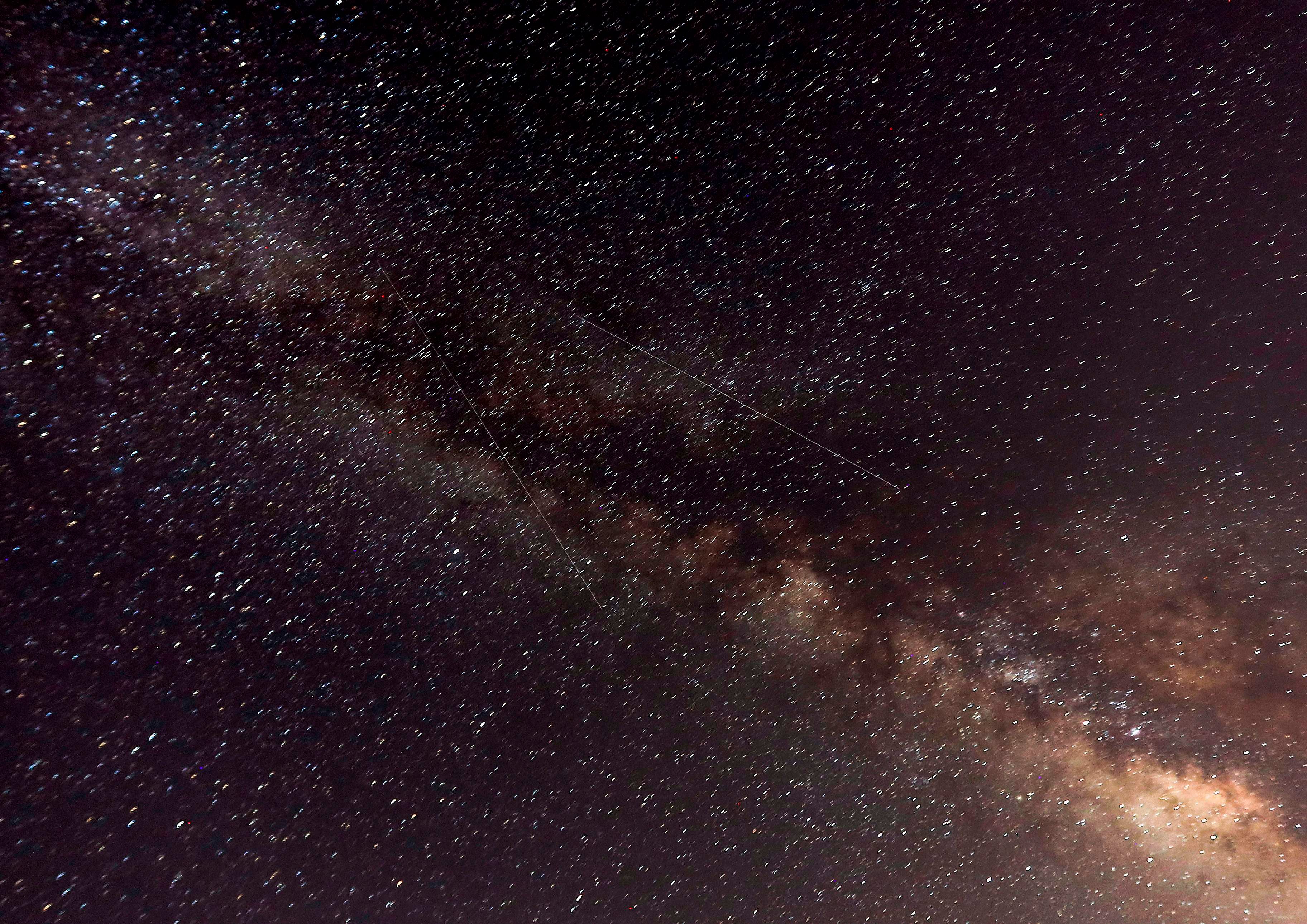 A picture taken late on August 12, 2018 shows meteors crossing the night sky past the Milky Way during the annual "Perseid" meteor show, in the mountain area of Tannourine in northern Lebanon. Credit: AFP File Photo