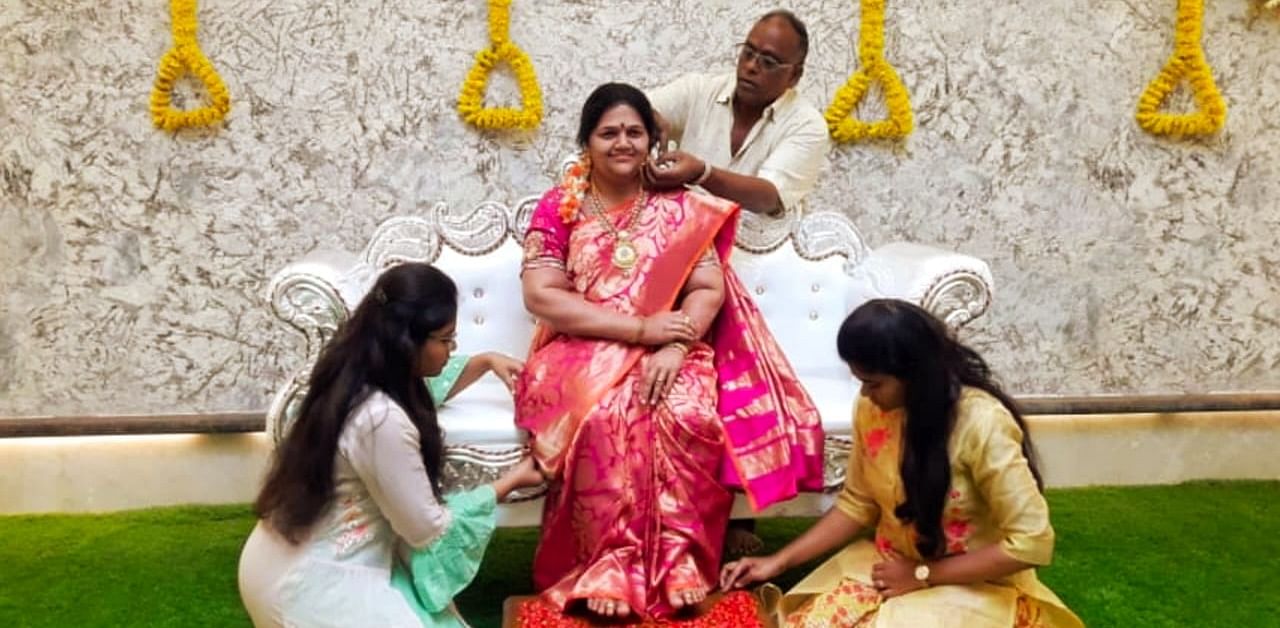 Industrialist Srinivas Gupta and his daughters decorating silicon statue of his wife Madhavi during house warming ceremony at Bhagya Nagar near Koppal. Madhavi died in accident in 2017.