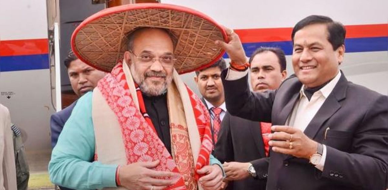 Union Home Minister Amit Shah is greeted by Assam Chief Minister Sarbananda Sonowal at the airport. Credit: PTI Photo