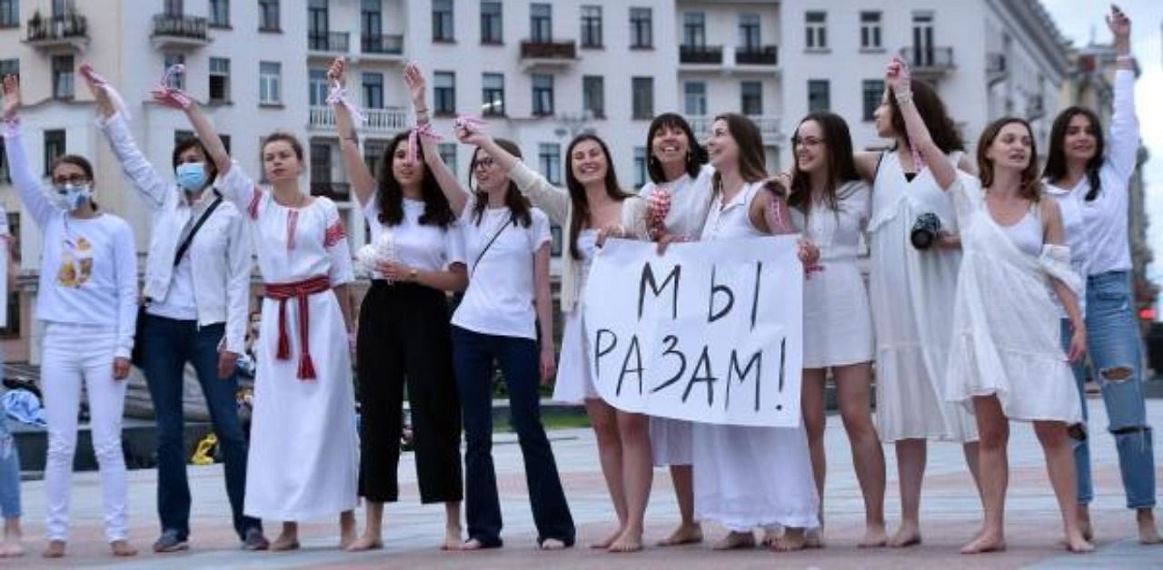 Women dressed in white clothes stand barefoot as they protest against police violence during recent rallies of opposition supporters, who accuse strongman Alexander Lukashenko of falsifying the polls in the presidential election, in Minsk. Credit: AFP