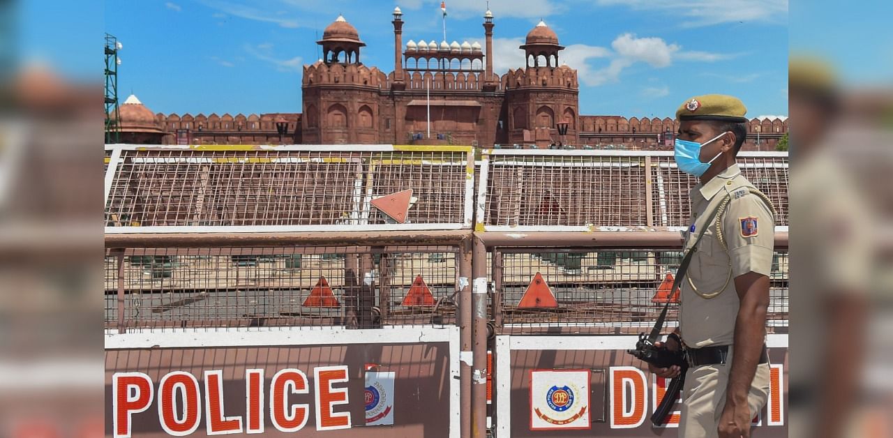 A security man patrols outside Red Fort ahead of the upcoming Independence Day celebrations, in New Delhi. Credit: PTI Photo