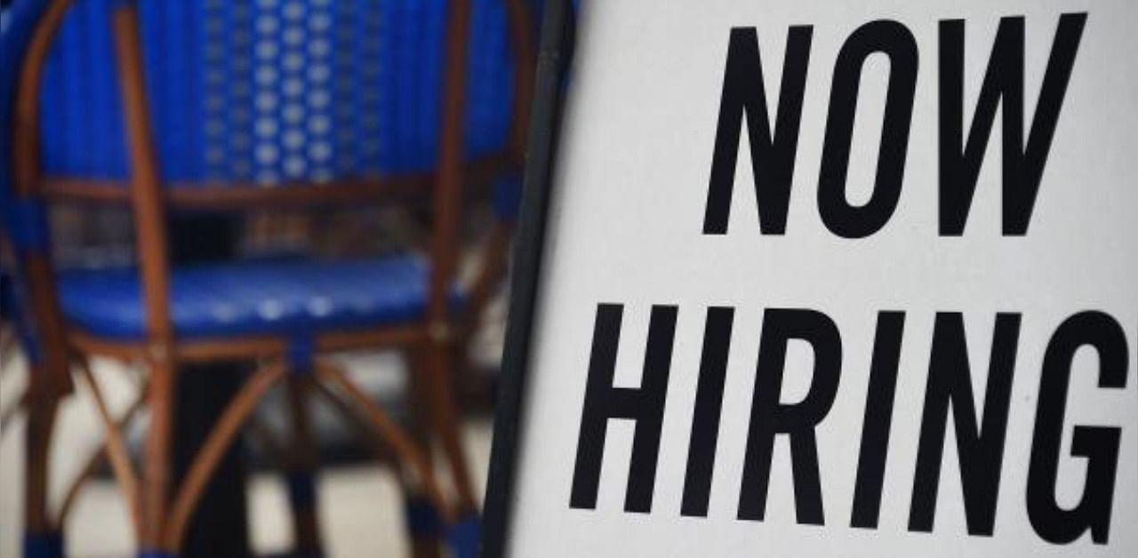 a restaurant displays a "Now Hiring" sign amid the coronavirus pandemic. Representative Image. Credit: AFP