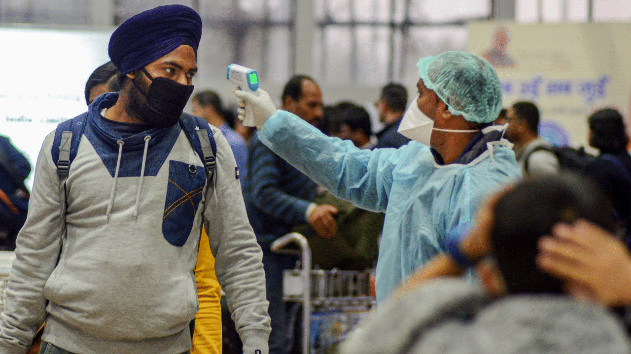 A medic official uses thermal screeing device on a passenger in the wake of deadly coronavirus. Credits: PTI Photo