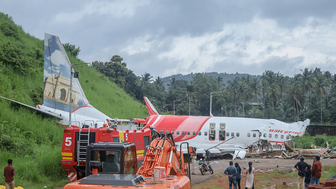 Mangled remains of an Air India Express flight, en route from Dubai, after it skidded off the runway while landing on Friday night, at Karippur in Kozhikode. Credits: PTI Photo