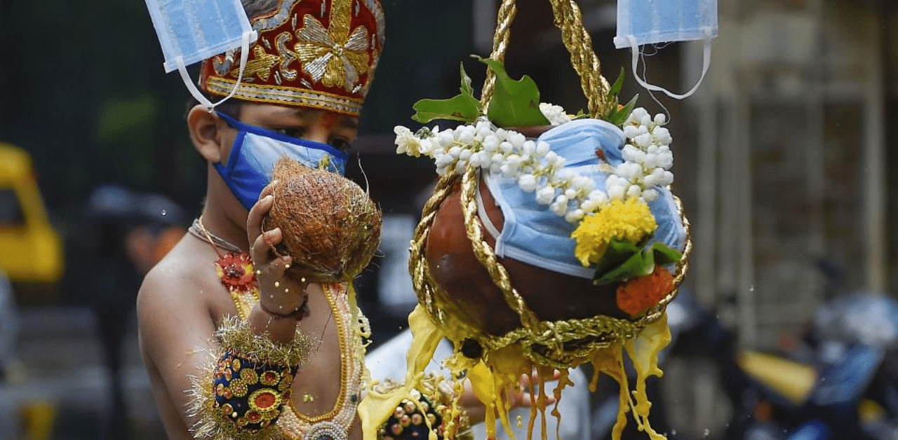  A child wearing a face mask and dressed as Lord Krishna breaks an earthen pot on the occasion of Janmashtami (Dahi Handi), at Dadar in Mumbai, Wednesday, Aug. 12, 2020. Credit: PTI Photo